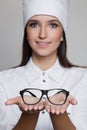 Close up portrait of woman doctor oculist giving glasses Royalty Free Stock Photo