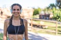 Close up portrait of a woman doing sport resting outdoor smiling and listening music Royalty Free Stock Photo