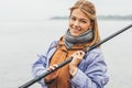 close-up portrait of woman with fishing rod looking Royalty Free Stock Photo