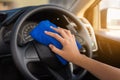 Close-up portrait of woman hand cleaning car steering wheel with Royalty Free Stock Photo