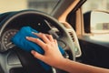 Close up portrait of woman hand cleaning car steering wheel. Royalty Free Stock Photo