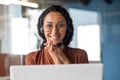 Close-up portrait of a woman with a headset, an online customer support worker smiling and looking at the camera, a Royalty Free Stock Photo