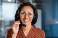 Close-up portrait of a woman with a headset, an online customer support worker smiling and looking at the camera, a Royalty Free Stock Photo