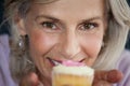 Close up portrait of woman holding cupcake Royalty Free Stock Photo