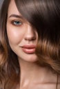 Close-up portrait of a woman. Luxurious hair covers part of her face