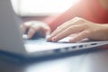 Close-up portrait of woman`s hands typing on laptop sitting at the table. Female businesswoman working on-line via laptop computer