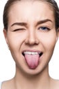 Close-up portrait of woman shows tongue grimace. Royalty Free Stock Photo