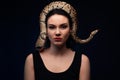 Close up portrait of woman with snake on head