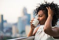 A close-up portrait of a woman standing on a terrace, drinking coffee. Royalty Free Stock Photo