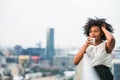 A close-up portrait of a woman standing on a terrace, drinking coffee. Royalty Free Stock Photo