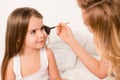 Close up portrait of woman doing maquillage to her cute daughter Royalty Free Stock Photo