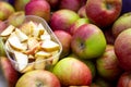 A close up portrait of a wooden crate full of apples at a local market. There is a plastic tray full of apple slices to taste the Royalty Free Stock Photo