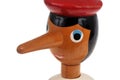Close-up portrait of wooden Pinocchio puppet on white background