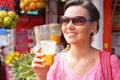 Yougn woman with glass of fresh fruit juice