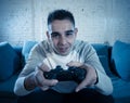 Close up portrait of young addicted man playing video game at night in gaming and addiction concept Royalty Free Stock Photo