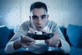 Close up portrait of young addicted man playing video game at night in gaming and addiction concept Royalty Free Stock Photo