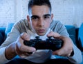 Close up portrait of young addicted man playing video game at night in gaming and addiction concept Royalty Free Stock Photo