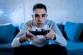 Close up portrait of young addicted man playing video game at night in gaming and addiction concept Royalty Free Stock Photo