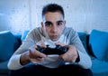 Close up portrait of young addicted man playing video game at night in gaming and addiction concept Royalty Free Stock Photo