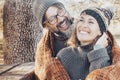 Close up portrait of young adult people laughing and having fun together in autumn park outdoor leisure activity. One man make Royalty Free Stock Photo