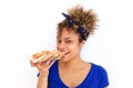 Close up young african american woman eating pizza against white background Royalty Free Stock Photo