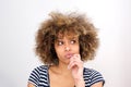 Close up young african woman thinking with hand on chin and and looking away