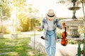 Close-up portrait of Young Asia woman music violinist bow after play violin, relax in the garden with peace of mind Royalty Free Stock Photo