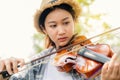 Close-up portrait of Young Asia woman music violinist play violin, relax in the garden with peace of mind Royalty Free Stock Photo