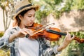 Close-up portrait of Young Asia woman music violinist play violin, relax in the garden with peace of mind Royalty Free Stock Photo