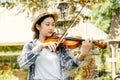 Close-up portrait of Young Asia woman music violinist play violin, relax in the garden with peace of mind Royalty Free Stock Photo