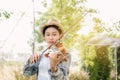 Close-up portrait of Young Asia woman music violinist play violin, relax in the garden with peace of mind Royalty Free Stock Photo