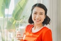 Close up portrait young Asian pregnant woman holding a glass of milk Royalty Free Stock Photo