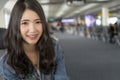 Close up Portrait young Asian woman in airport terminal. Royalty Free Stock Photo