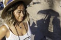 Close up portrait of a young Asian woman relaxing on the beach in Lisbon, Portugal. Beautiful woman wearing a stylish hat and Royalty Free Stock Photo