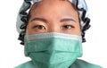 Close up portrait of young attractive and confident Asian Korean medicine doctor woman in head cap face mask and scrubs in Royalty Free Stock Photo