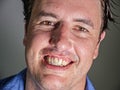 Close up portrait of young attractive and confident entrepreneur man in casual shirt smiling happy and positive looking at the Royalty Free Stock Photo