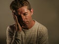 Close up portrait of young attractive man with fingers on head tempo in stress suffering headache feeling worried and depressed in Royalty Free Stock Photo