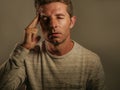 Close up portrait of young attractive man with fingers on head tempo in stress suffering headache feeling worried and depressed in Royalty Free Stock Photo