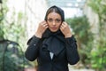 Close-up portrait of young and attractive muslim woman in hijab. Middle Eastern woman outdoor on the street. City Royalty Free Stock Photo