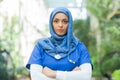 Close-up portrait of young and attractive muslim woman nurse in hijab. Middle Eastern female doctor outdoor on the Royalty Free Stock Photo