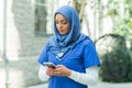 Close-up portrait of young and attractive muslim woman nurse in hijab. Middle Eastern female doctor outdoor on the Royalty Free Stock Photo