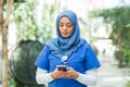 Close-up portrait of young and attractive muslim woman nurse in hijab. Middle Eastern female doctor outdoor on the Royalty Free Stock Photo