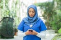 Close-up portrait of young and attractive muslim woman nurse in hijab. Middle Eastern female doctor outdoor on the Royalty Free Stock Photo