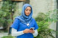 Close-up portrait of young and attractive muslim woman nurse in hijab. Middle Eastern female doctor outdoor on the Royalty Free Stock Photo