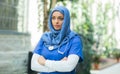 Close-up portrait of young and attractive muslim woman nurse in hijab. Middle Eastern female doctor outdoor on the Royalty Free Stock Photo