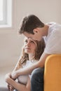 Close up portrait of young attractive romantic couple hugging and kissing, laying down on a bed, being loving with each other. Royalty Free Stock Photo