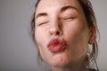 Close-up portrait of young attractive woman blowing a kiss. Studio horizontal shot. Royalty Free Stock Photo