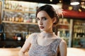 Close-up portrait of a young attractive woman in a 1920s style at the bar. Model with a beautiful make-up Royalty Free Stock Photo
