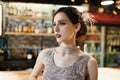 Close-up portrait of a young attractive woman in a 1920s style at the bar. Model with a beautiful make-up Royalty Free Stock Photo