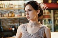 Close-up portrait of a young attractive woman in a 1920s style at the bar. Model with a beautiful make-up Royalty Free Stock Photo